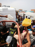 Palestinians Queue for Water in Gaza Amid Hamas-Israel Conflict