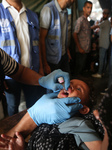 Palestinian Child Receives Polio Vaccine at UN Center in Gaza Amid Conflict