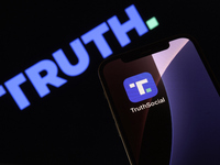 Truth Social App Displayed On IPhone With Logo In Background