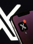 X App Icon On IPhone With Logo In Background