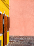 Child Scooting Past Colorful Walls In Burano