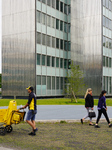 German Postman Passing A Skyscraper