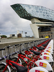 Velo Antwerp Bikes With Port House. An Iconic View Of Urban Sustainability