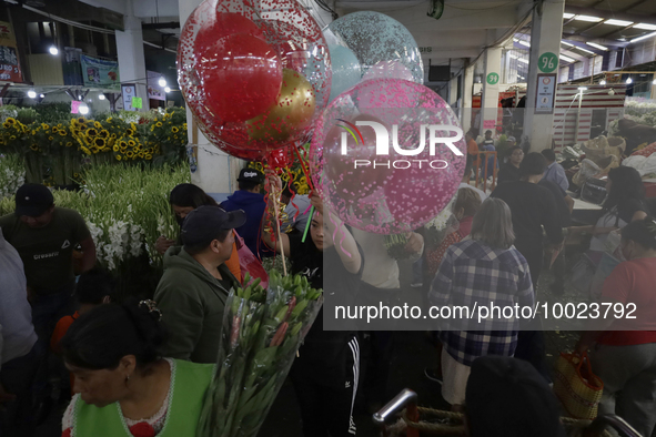 A woman holds several balloons inside the Jamaica Market in Mexico City where dozens of people came to buy flowers and gifts for Mother's Da...