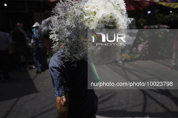 A person holds a bouquet of flowers inside the Jamaica Market in Mexico City where dozens of people came to buy flowers and gifts for Mother...