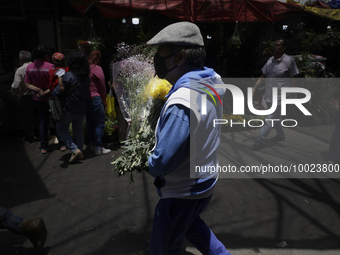 A person holds a bouquet of flowers inside the Jamaica Market in Mexico City where dozens of people came to buy flowers and gifts for Mother...