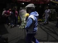 A person holds a bouquet of flowers inside the Jamaica Market in Mexico City where dozens of people came to buy flowers and gifts for Mother...