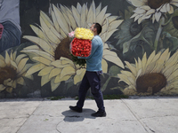 A person holds a bouquet of flowers inside the Jamaica Market in Mexico City where dozens of people came to buy flowers and gifts for Mother...