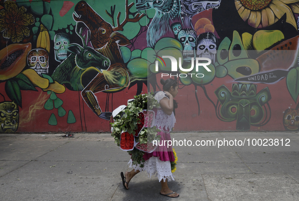 A woman holds a bouquet of flowers outside the Jamaica Market in Mexico City where dozens of people came to buy flowers and gifts for Mother...