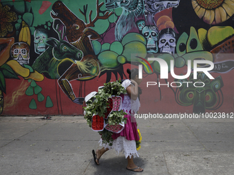 A woman holds a bouquet of flowers outside the Jamaica Market in Mexico City where dozens of people came to buy flowers and gifts for Mother...