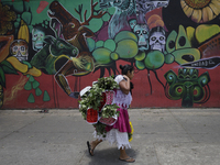 A woman holds a bouquet of flowers outside the Jamaica Market in Mexico City where dozens of people came to buy flowers and gifts for Mother...