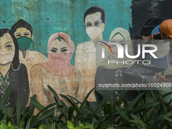 Municipal worker removed a mural promoting awareness of the coronavirus disease (Covid-19) and replaced it with another image in Jakarta, In...