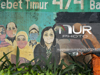 Municipal worker removed a mural promoting awareness of the coronavirus disease (Covid-19) and replaced it with another image in Jakarta, In...