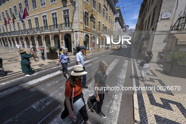 People are seen walking along one of the streets in the neighborhood of Baixa, Lisbon. 02 May 2023.  