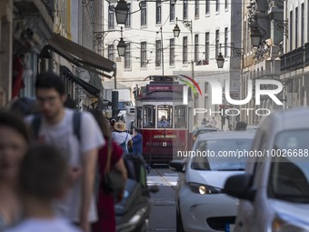 Trams are seen passing through one of the streets in the neighborhood of Baixa, Lisbon. 02 May 2023. (