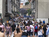 People are seen walking near the Augusta arch in Praca de Comercio, in the Baixa neighborhood, Lisbon. 02 May 2023. (