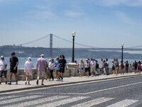 Several people are seen walking near the Tejo river bank, in the Baixa neighborhood, Lisbon. 02 May 2023. (