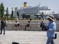 Several people are seen walking along the banks of the Tejo river, in the Baixa neighborhood, Lisbon. 02 May 2023. (