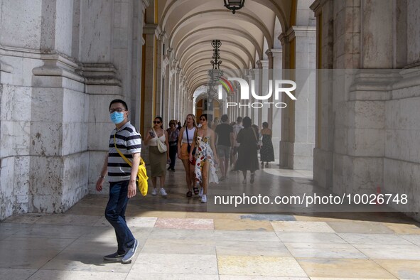 A person wearing a protective mask is seen walking near the Augusta arch, in the Baixa district, Lisbon. May 02, 2023. 