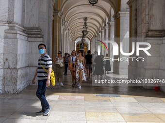 A person wearing a protective mask is seen walking near the Augusta arch, in the Baixa district, Lisbon. May 02, 2023. (