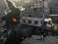 A picture shows a house being hit by an Israeli air strike in Gaza city on May 13, 2023. Israeli air strikes battered Gaza and militants fir...