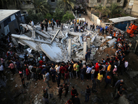 Palestinians inspect the rubble of a house after it was hit by an Israeli air strike in Gaza city on May 13, 2023. Israeli air strikes batte...