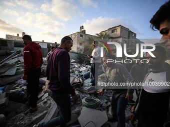 Palestinians inspect the rubble of a house after it was hit by an Israeli air strike in Gaza city on May 13, 2023. Israeli air strikes batte...
