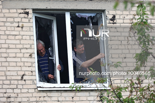 ZOLOCHIV, UKRAINE - MAY 14, 2023 - Men remove glass shards after the rocket attack by Russia that, allegedly, used S-300 surface-to-air miss...