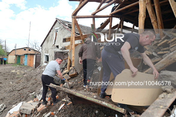 ZOLOCHIV, UKRAINE - MAY 14, 2023 - Men clear away the debris after the rocket attack by Russia that, allegedly, used S-300 surface-to-air mi...