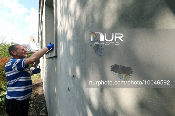 ZOLOCHIV, UKRAINE - MAY 14, 2023 - A man clears away the debris after the rocket attack by Russia that, allegedly, used S-300 surface-to-air...