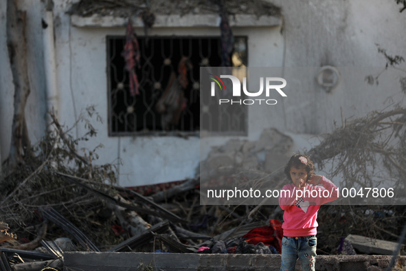 A Palestinian girl stands past a house destroyed in an Israeli strike in the recent Gaza-Israel fighting, following a ceasefire agreed betwe...