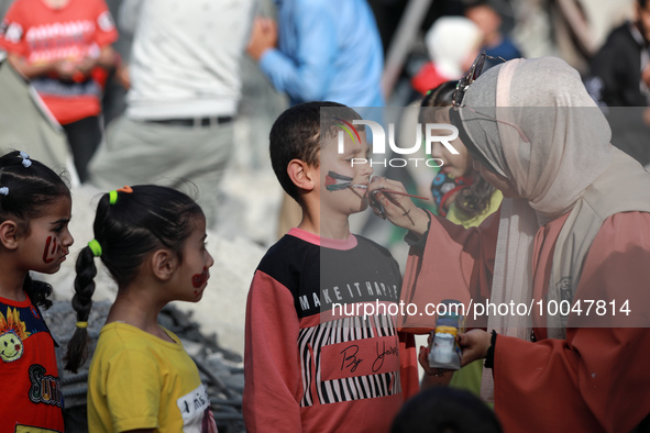 A Palestinian boy gets his face painted during an activity aimed to support the mental health of children affected by the recent Israel-Gaza...