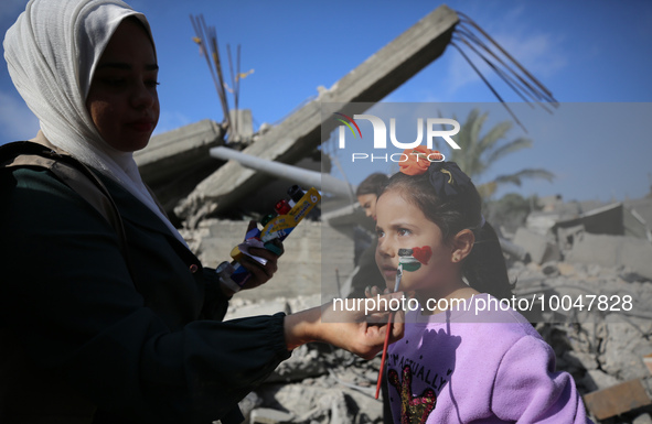 A Palestinian girl gets her face painted during an activity aimed to support the mental health of children affected by the recent Israel-Gaz...