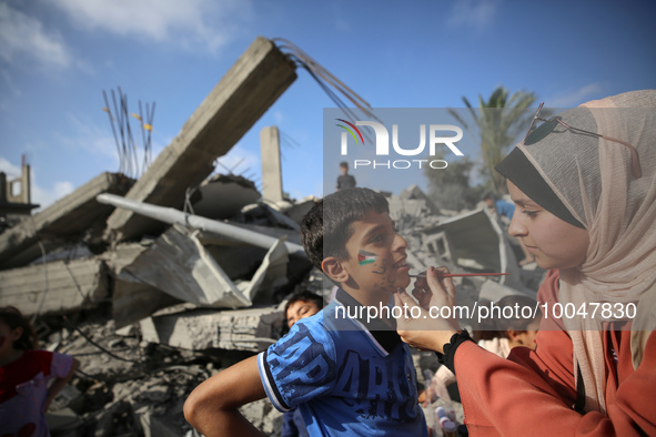 A Palestinian boy gets his face painted during an activity aimed to support the mental health of children affected by the recent Israel-Gaza...