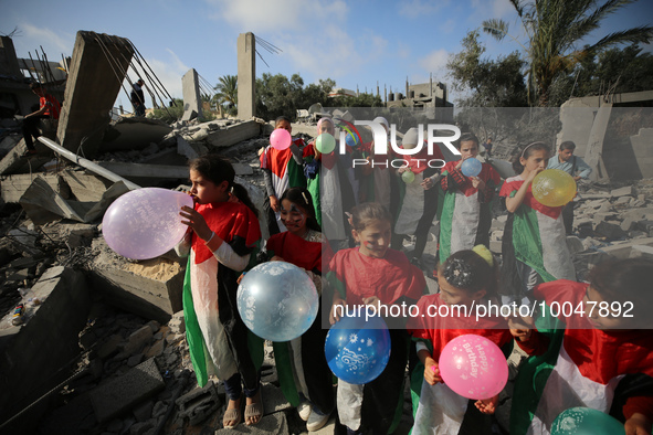 Palestinian children participate in an activity aimed to support the mental health of children affected by the recent Israel-Gaza fighting,...