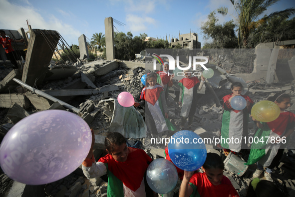 Palestinian children participate in an activity aimed to support the mental health of children affected by the recent Israel-Gaza fighting,...