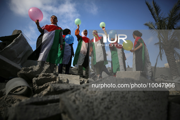 Palestinian children participate in an activity aimed to support the mental health of children affected by the recent Israel-Gaza fighting,...