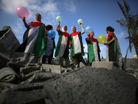 Palestinian children participate in an activity aimed to support the mental health of children affected by the recent Israel-Gaza fighting,...