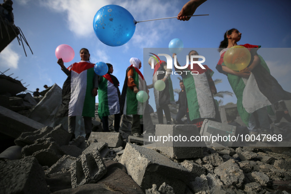 Palestinian children participate in an activity aimed to support the mental health of children affected by the recent Israel-Gaza fighting,...