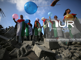 Palestinian children participate in an activity aimed to support the mental health of children affected by the recent Israel-Gaza fighting,...