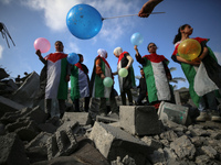 Palestinian children participate in an activity aimed to support the mental health of children affected by the recent Israel-Gaza fighting,...