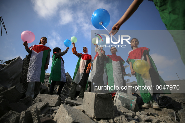 Palestinian children participate in an activity aimed to support the mental health of children affected by the recent Israel-Gaza fighting,...