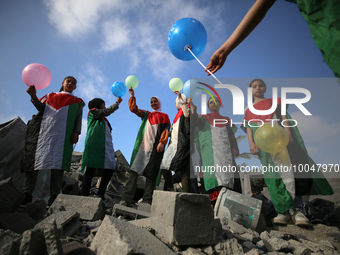 Palestinian children participate in an activity aimed to support the mental health of children affected by the recent Israel-Gaza fighting,...