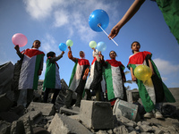 Palestinian children participate in an activity aimed to support the mental health of children affected by the recent Israel-Gaza fighting,...