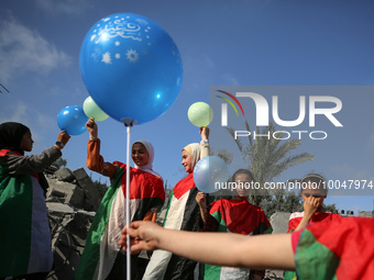 Palestinian children participate in an activity aimed to support the mental health of children affected by the recent Israel-Gaza fighting,...