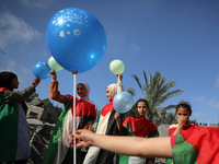 Palestinian children participate in an activity aimed to support the mental health of children affected by the recent Israel-Gaza fighting,...