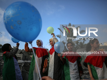 Palestinian children participate in an activity aimed to support the mental health of children affected by the recent Israel-Gaza fighting,...