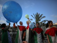 Palestinian children participate in an activity aimed to support the mental health of children affected by the recent Israel-Gaza fighting,...