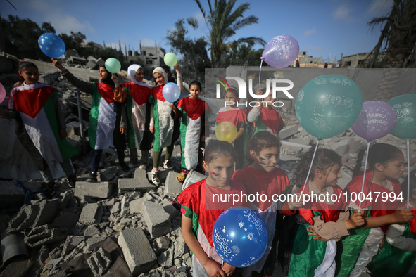 Palestinian children participate in an activity aimed to support the mental health of children affected by the recent Israel-Gaza fighting,...