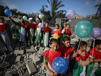 Palestinian children participate in an activity aimed to support the mental health of children affected by the recent Israel-Gaza fighting,...